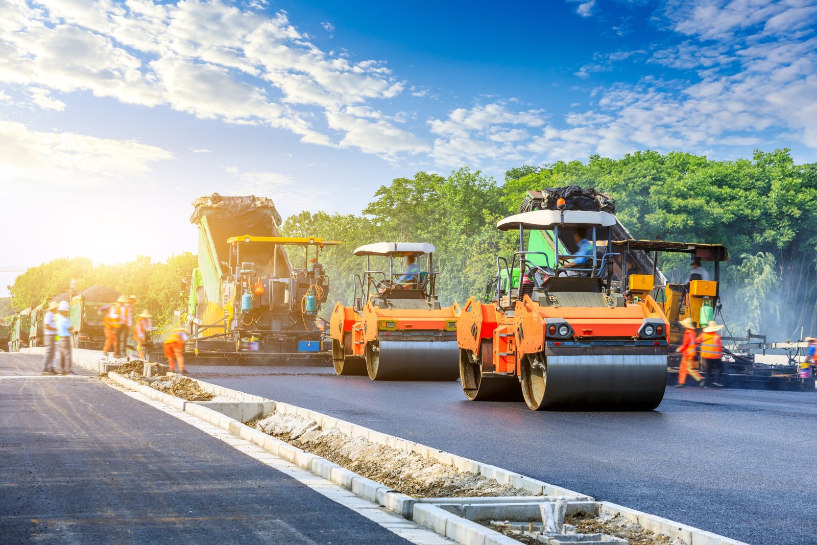 Construction site is laying new asphalt road pavement,road construction workers and road construction machinery scene.